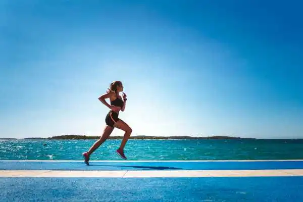 Woman running showing strong leg muscle Ashbourne